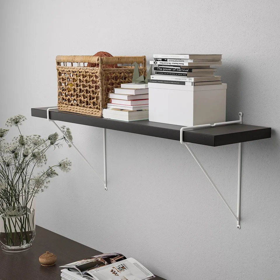 Wall-mounted shelf with storage items, including basket, books, and boxes. The shelf has bevelled and smooth edges.