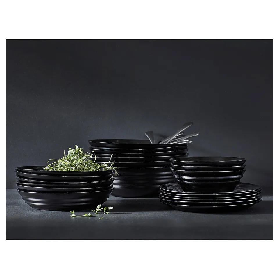 Black dishware set, glass, stackable, circular ripples design.