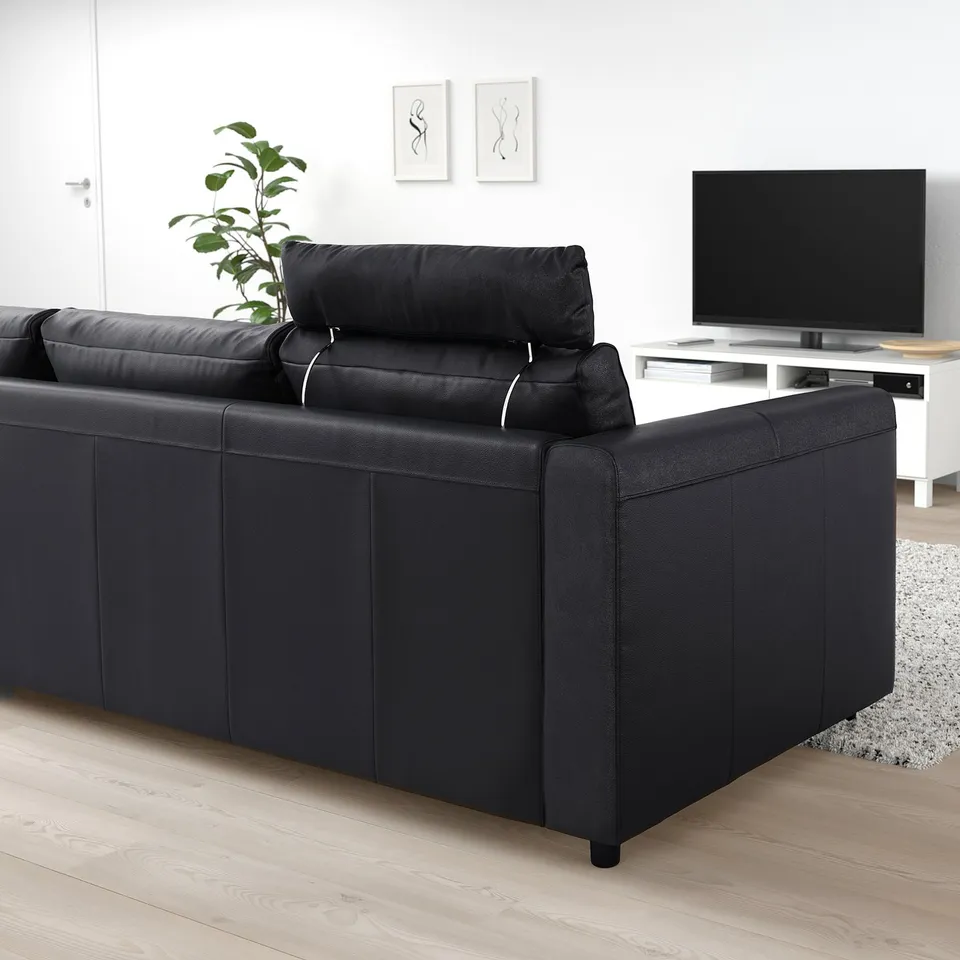 VIMLE black sofa with headrest, modern design, fits well in living space.