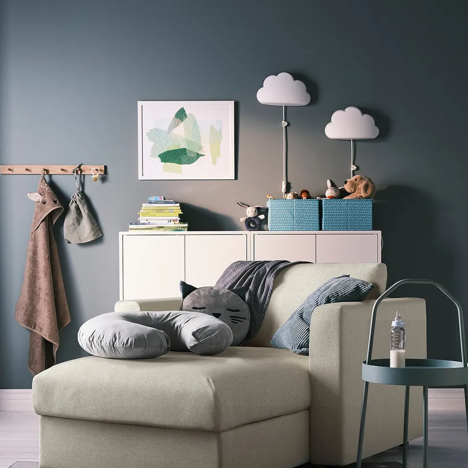 A modern, grey VIMLE sectional sofa with storage, pillows, and a side table in a stylish living space.
