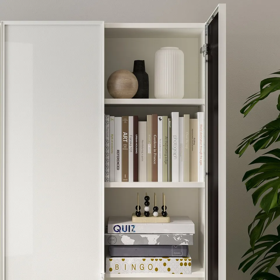 White BILLY bookcase with 3 shelves, displaying books, vases, and games.