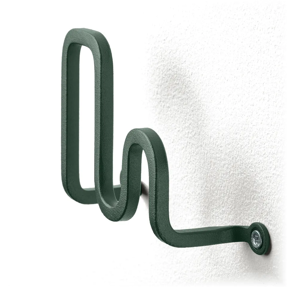 Green wave-shaped wall hook, modern design, mounted on white wall. Durable powder-coated steel.
