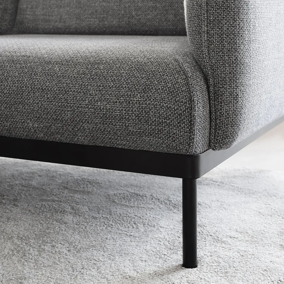 Modern, grey sofa with sleek metal legs.
