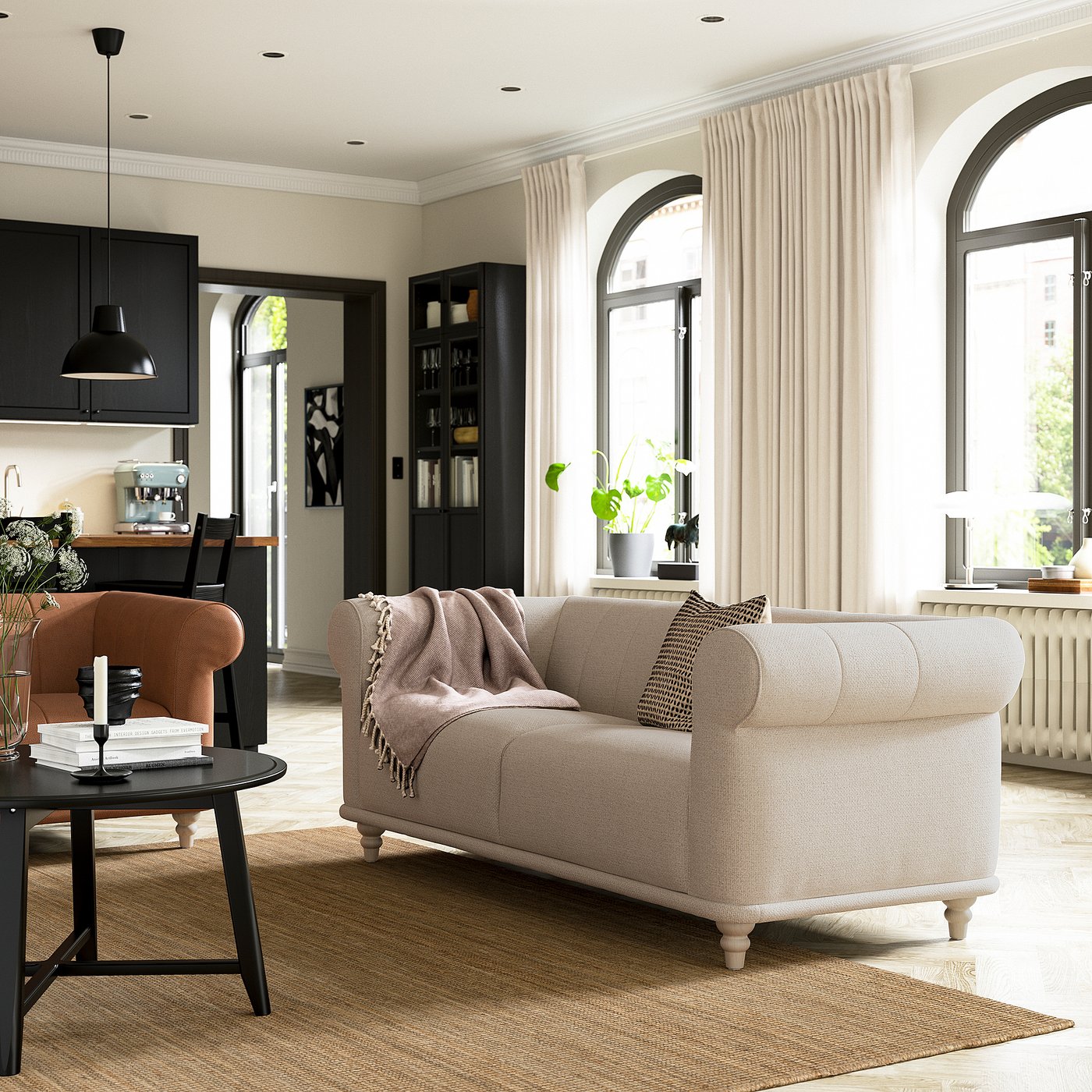 Modern living room a white VISKAFORS sofa, orange chair, black accessories, and large arched windows with sheer curtains.