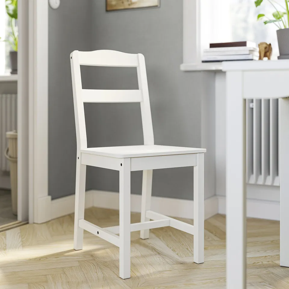 White wooden HAUGA chair, simple design, fits under table.
