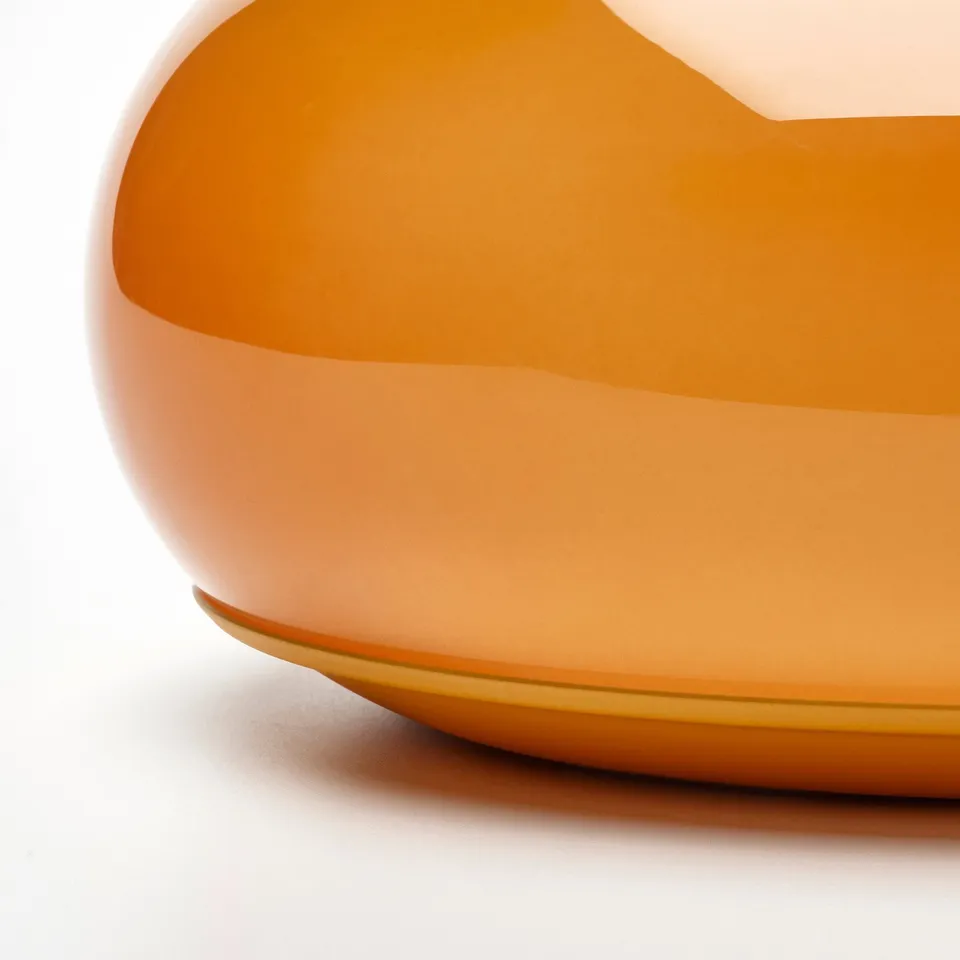 Sleek, modern amber glass lamp with smooth edges. Elegant design, quality craftsmanship.