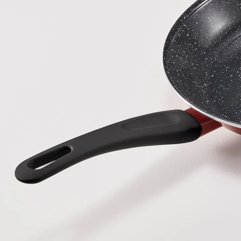 Modern frying pan with black handle and speckled non-stick surface.