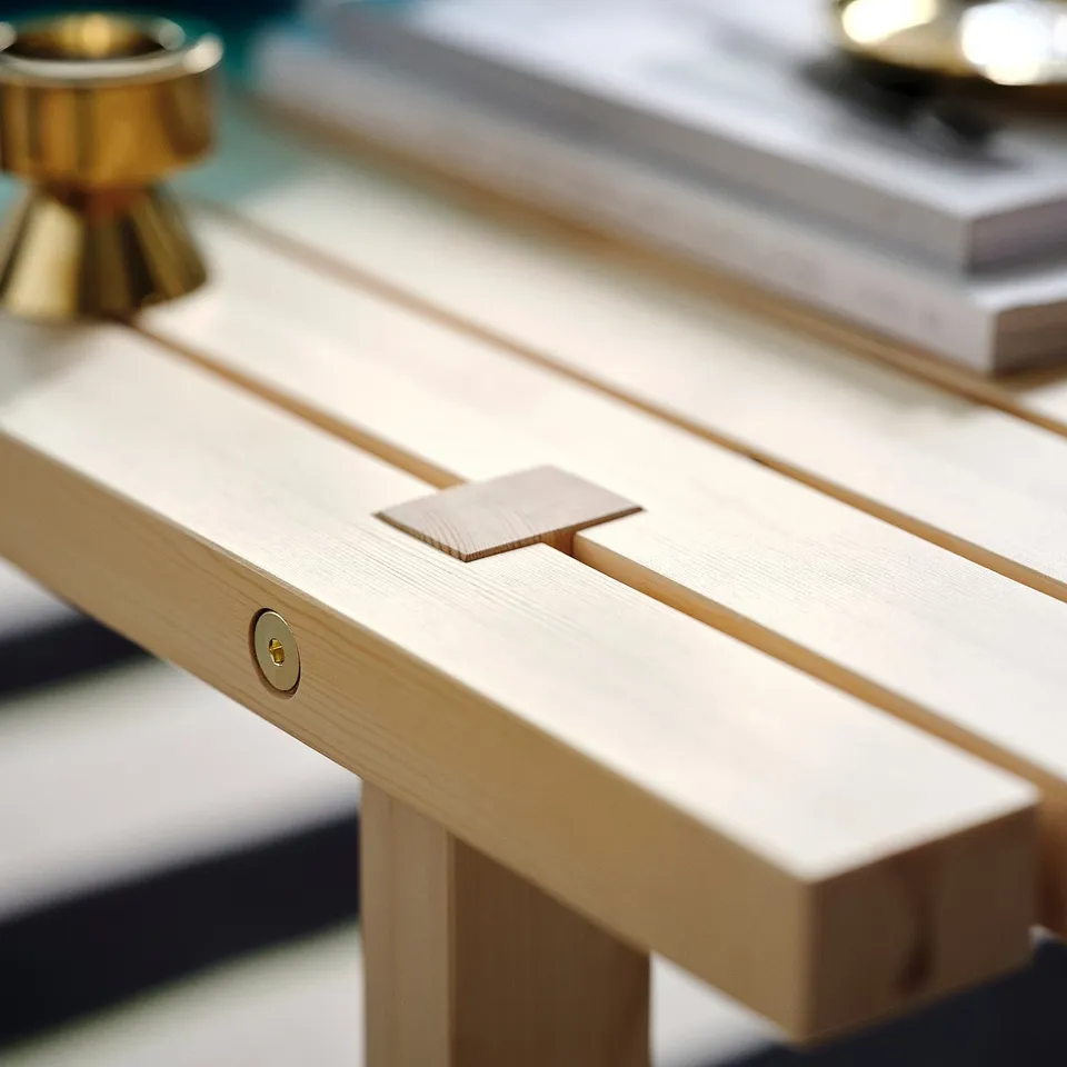 A sleek coffee table with a natural wood finish, showcasing high-quality craftsmanship and a smooth, polished top.