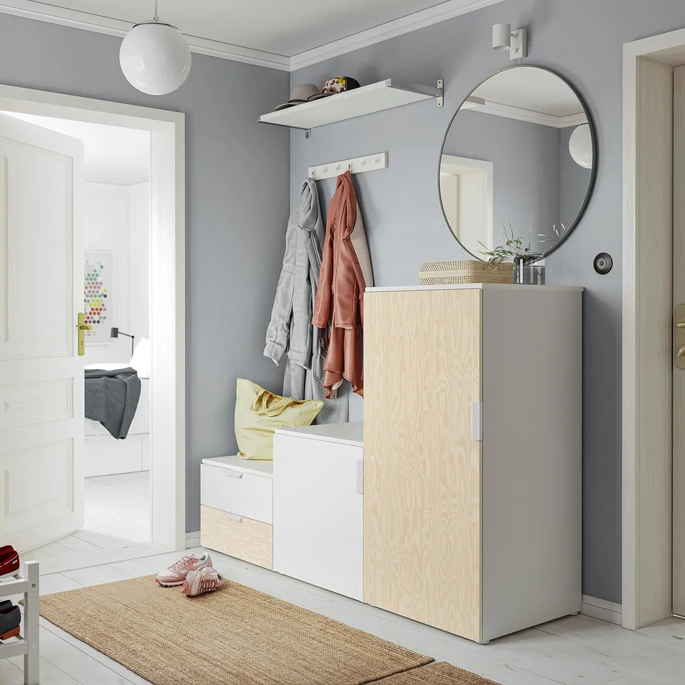 Minimalist entryway with grey PLATSA storage, white decor, and jute rug.