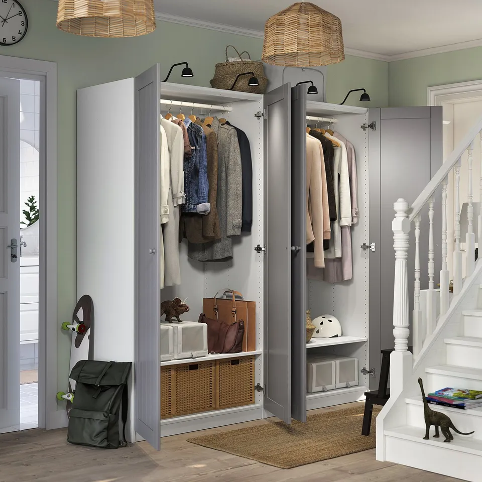 Modern entryway with open wardrobe, pendant lights, and cat.
