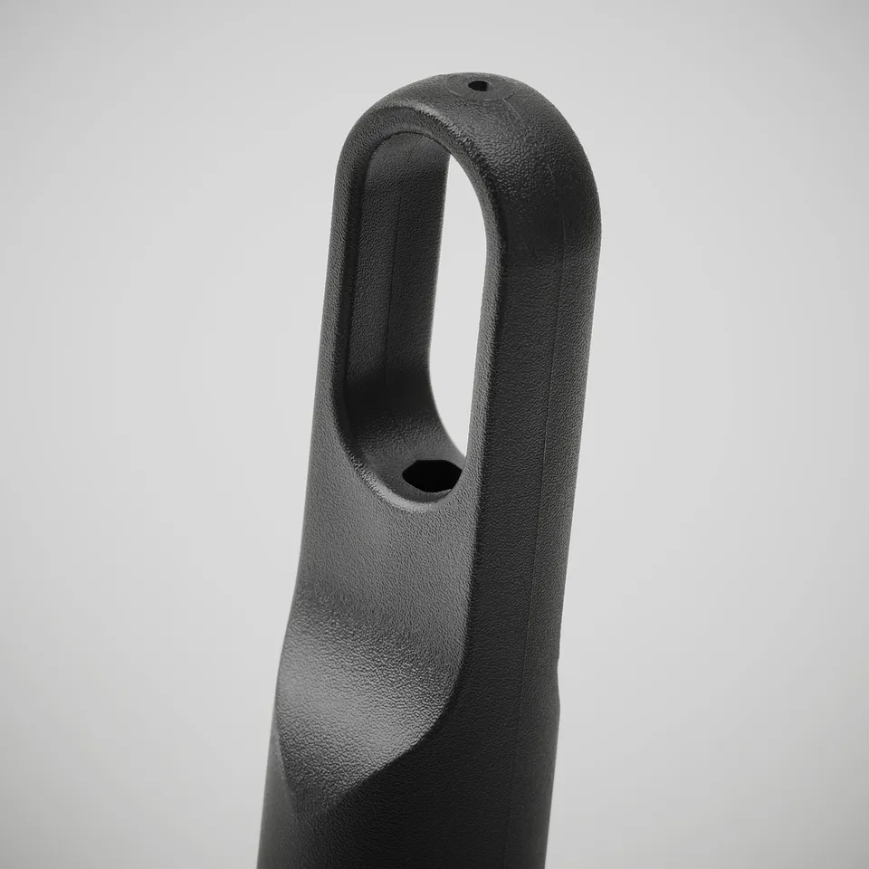 Black plastic kitchen roll holder with a handle for easy carrying, textured surface.