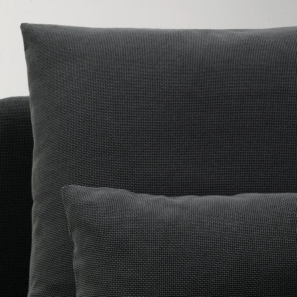 Close-up of modern, textured, grey fabric on a sleek sofa, showcasing high-quality upholstery and design.