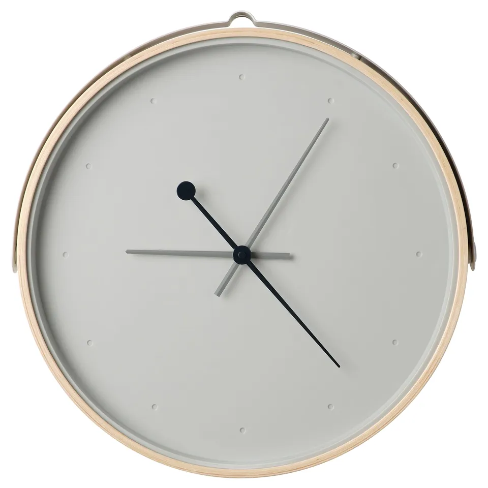 A modern, round, white rotblota clock with a silent quartz movement, featuring grey hands on a glass face surrounded by an ash veneer frame.