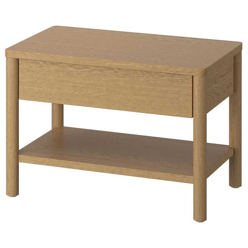 A TONSTAD wooden side table with a light oak finish. It a single drawer and an open shelf, designed with clean lines for versatile use.