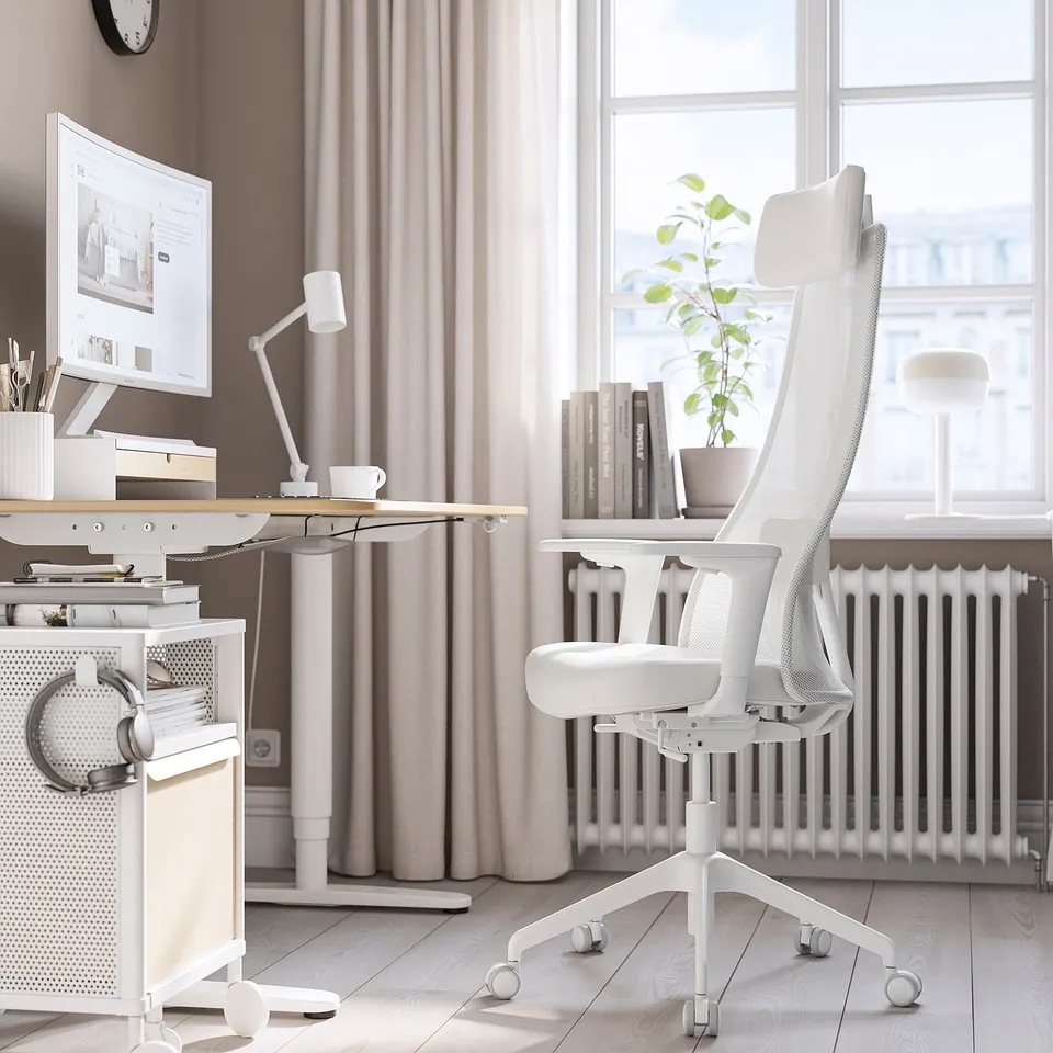 Modern home office with white JÄRVFJÄLLET ergonomic office chair, sleek desk, and large window. Light-filled, spacious setup.