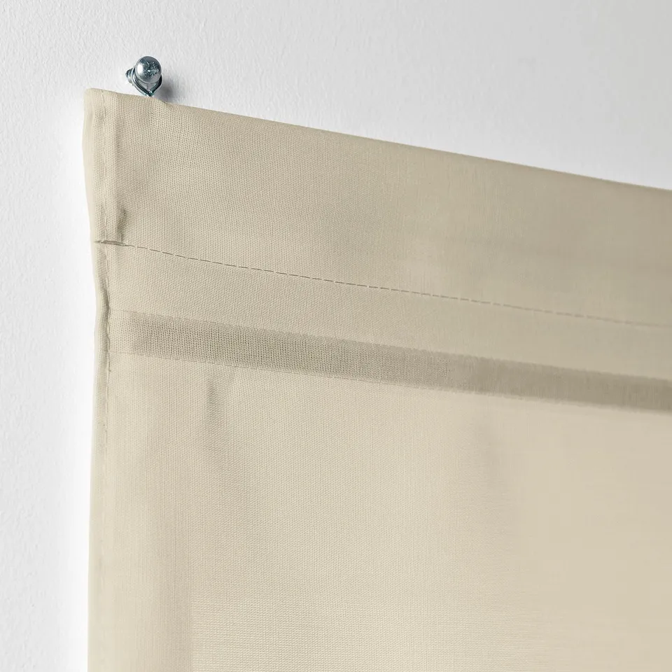 Beige RINGBLOMMA roman blind with linen look, featuring slot heading for easy installation and cordless operation for safety.