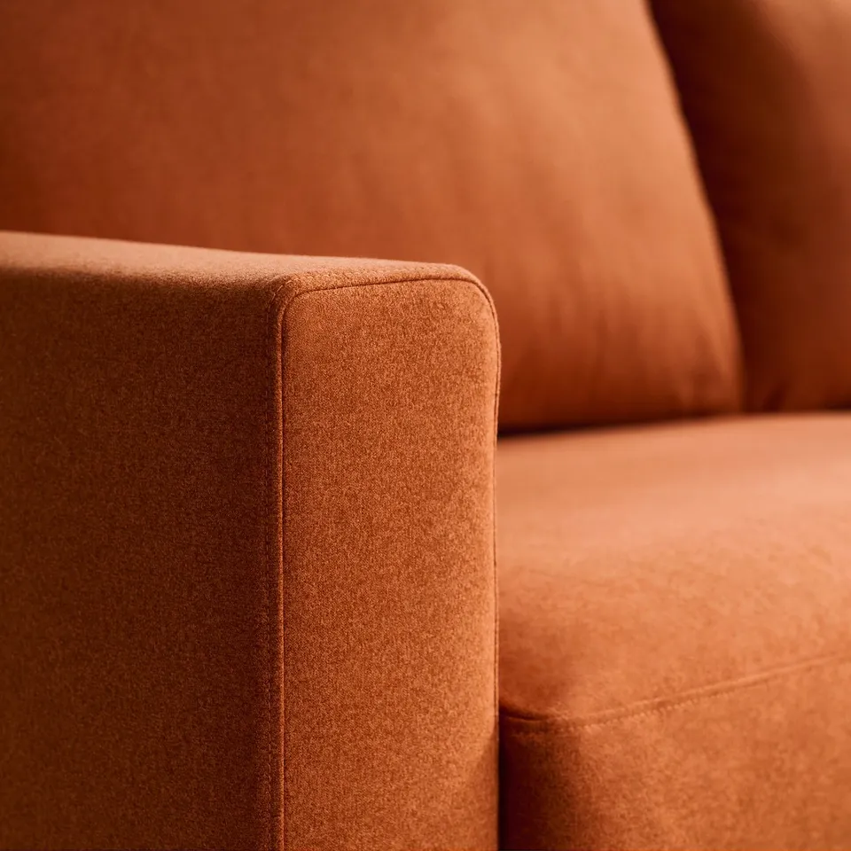 Close-up of brown upholstered furniture, highlighting soft, textured fabric and clean, modern design.