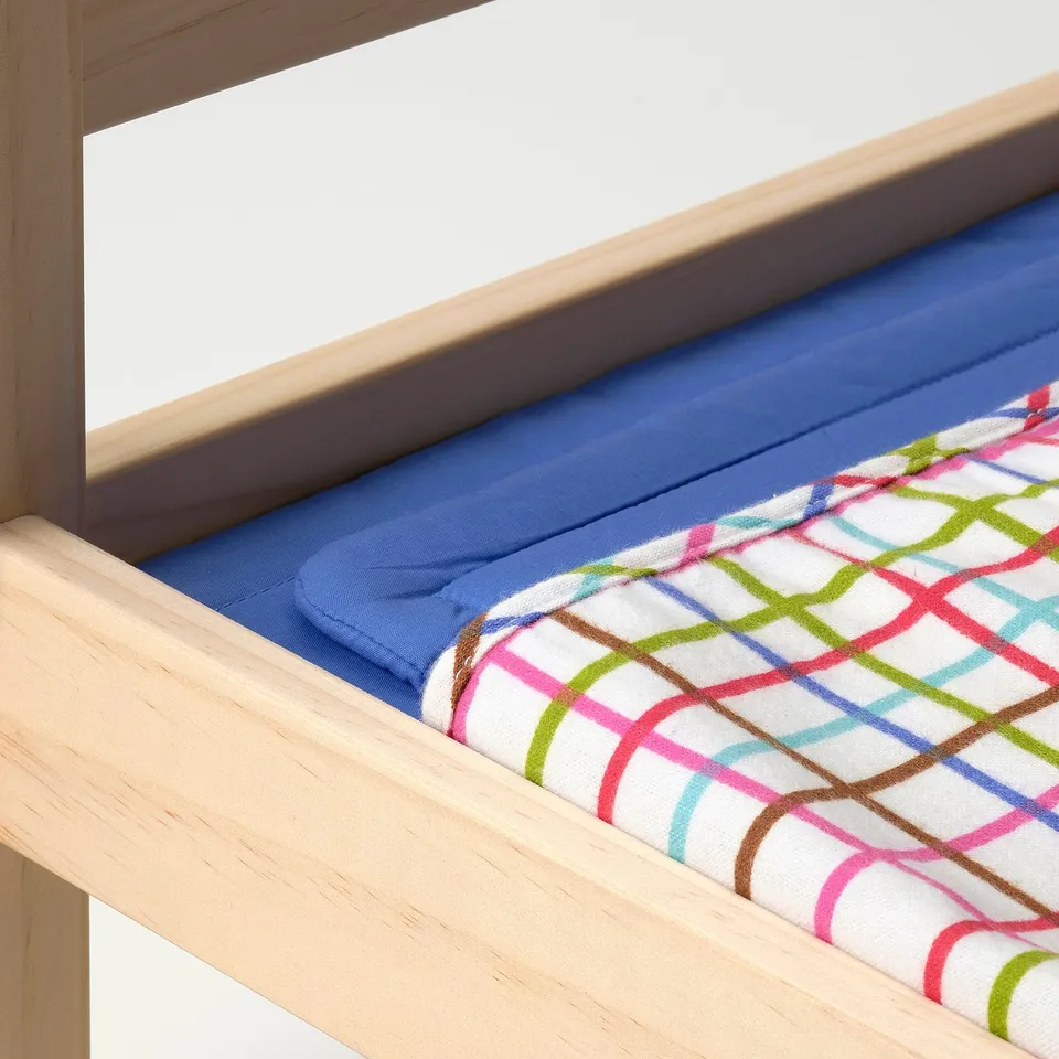 Wooden doll bed with colourful, cosy blanket and pillow. Ideal for pretend play.