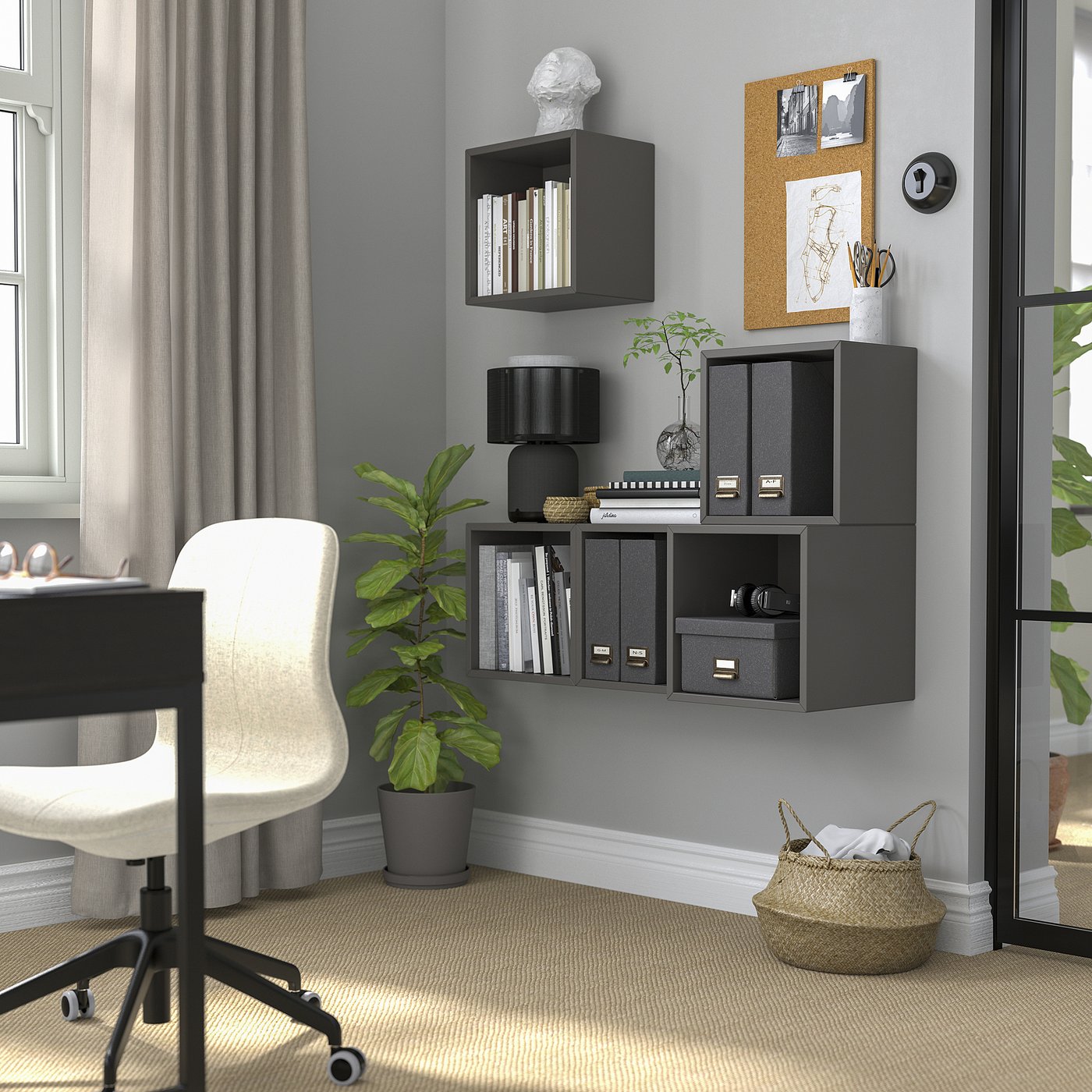 Black wall-mounted shelves store books & decor, with plant & chair below.