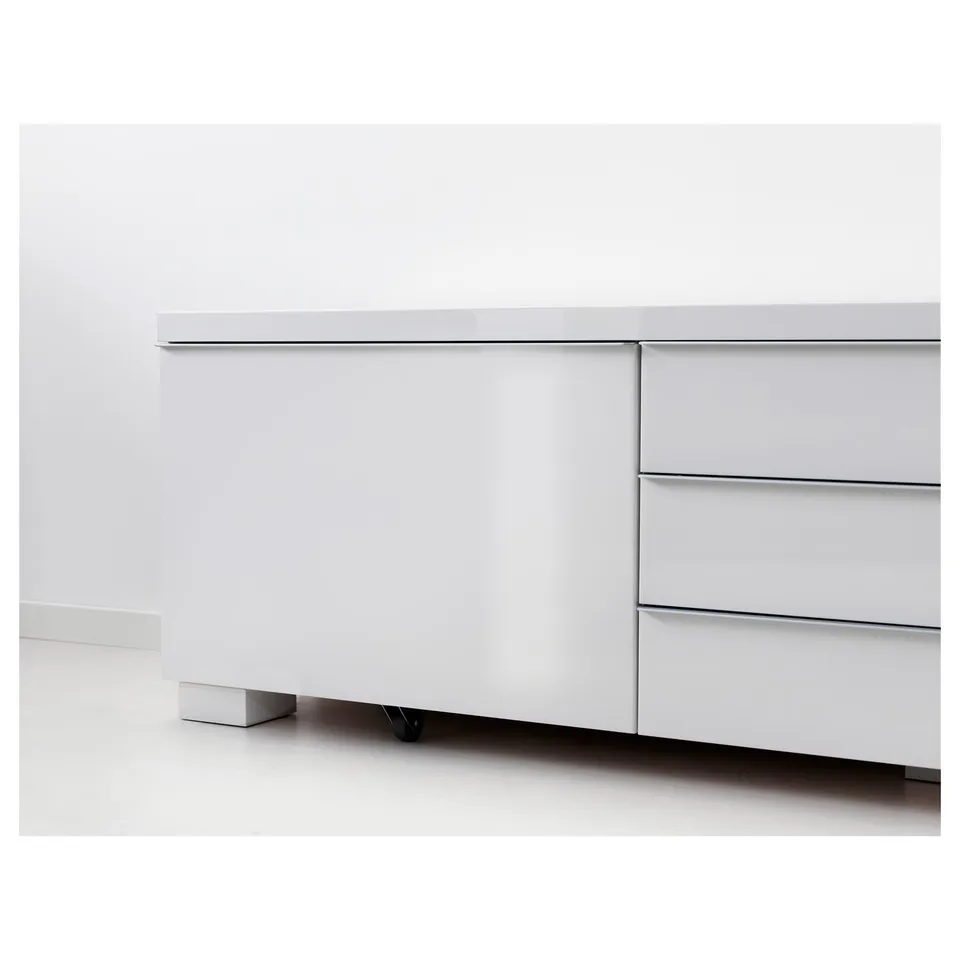 Modern white tv stand with glossy finish, featuring spacious drawers for storage.