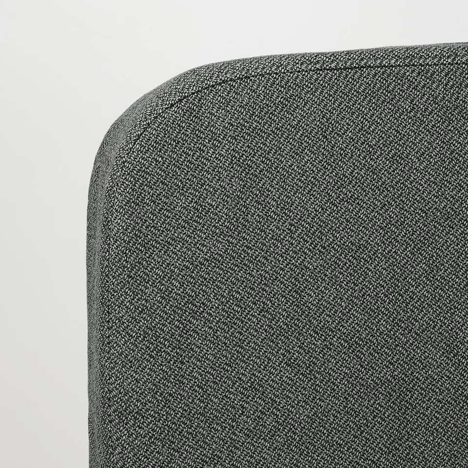 Close-up of NYHAMN sofa beds corner, showcasing high-quality, textured fabric. Its robust construction ensures durability and comfort.