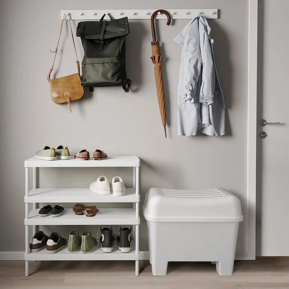 White stool, hooks with bags, umbrella, shoe rack