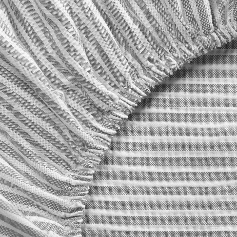 Black and white striped bed sheets, folded neatly, showcasing quality cotton texture.