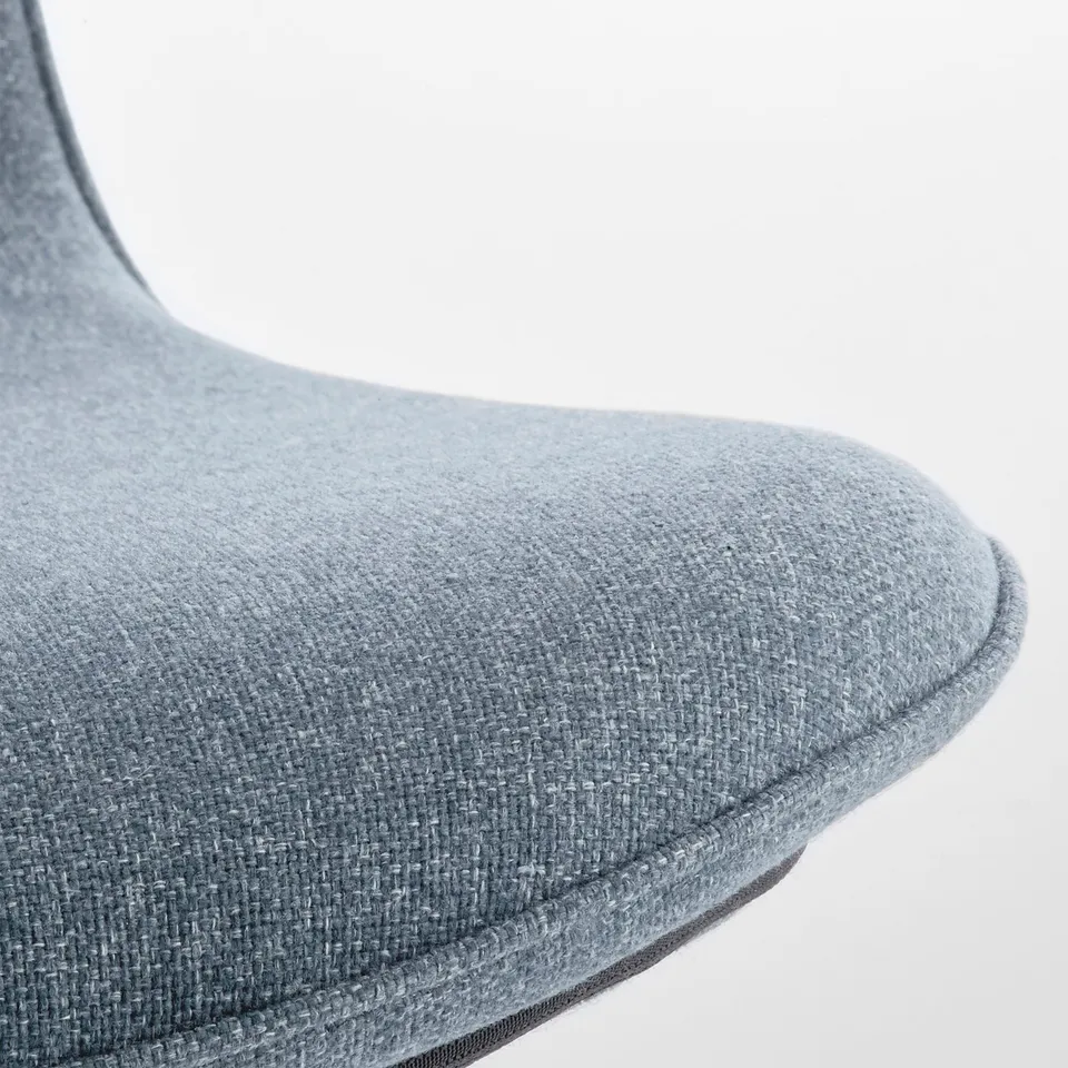 Close-up of chairs curved, grey upholstered section; detailed stitching evident.