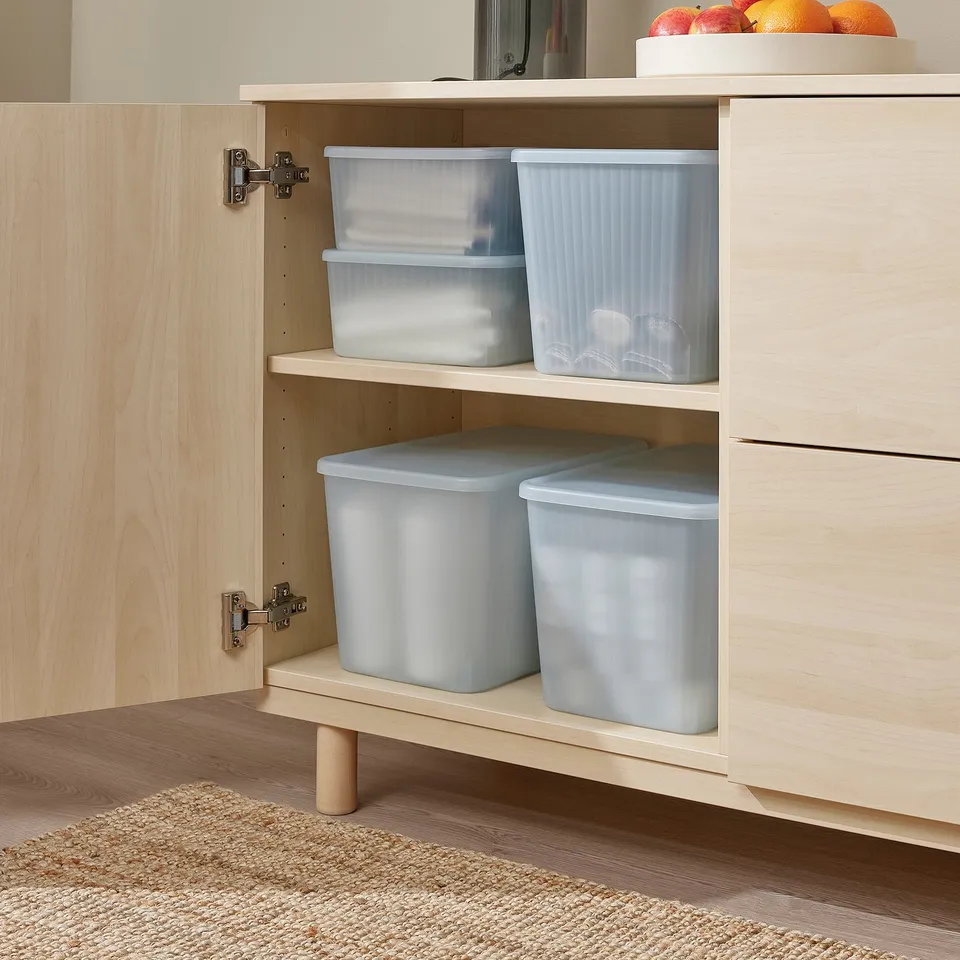 Wooden cabinet with light blue storage boxes. Boxes have lids and are stacked on shelves for easy access and organisation.