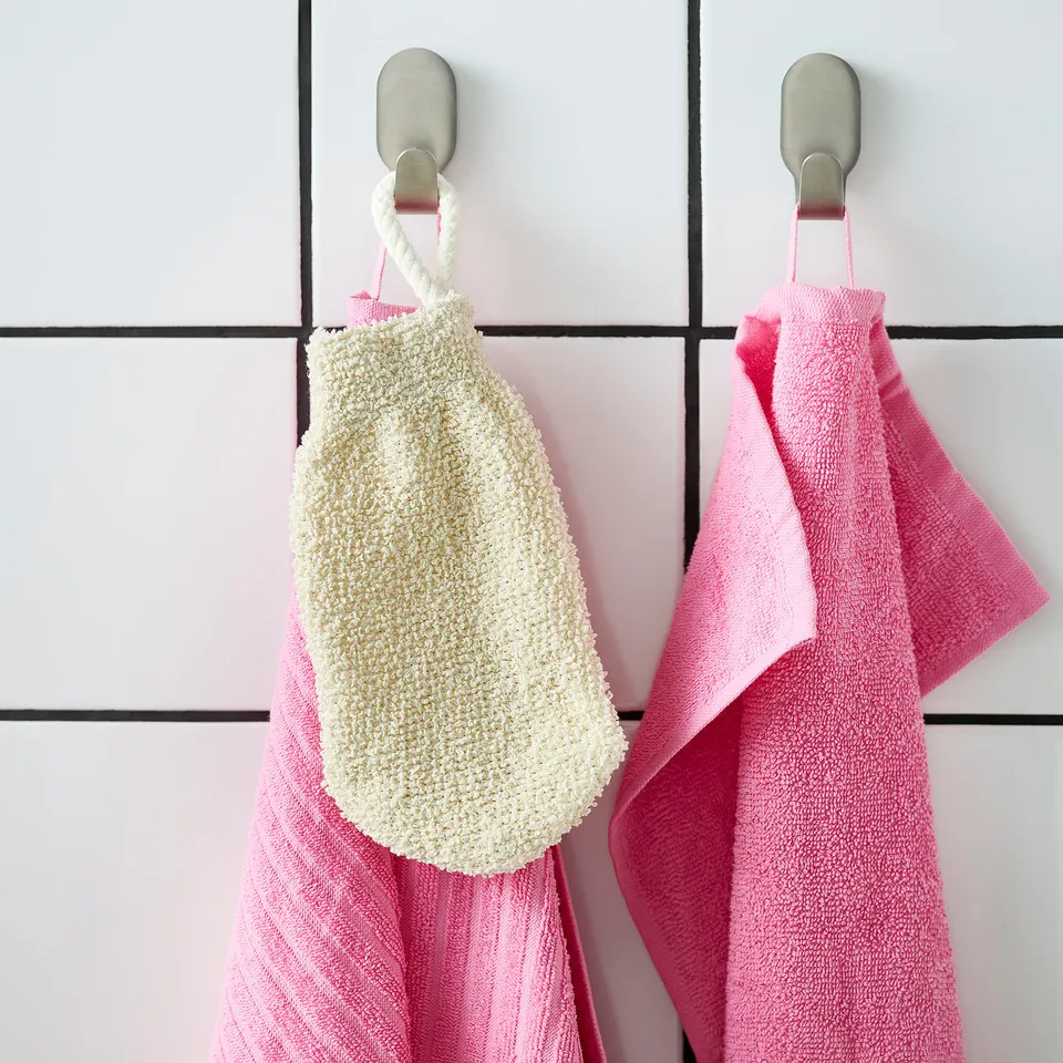 Towel hooks with scrub mitt and towels.