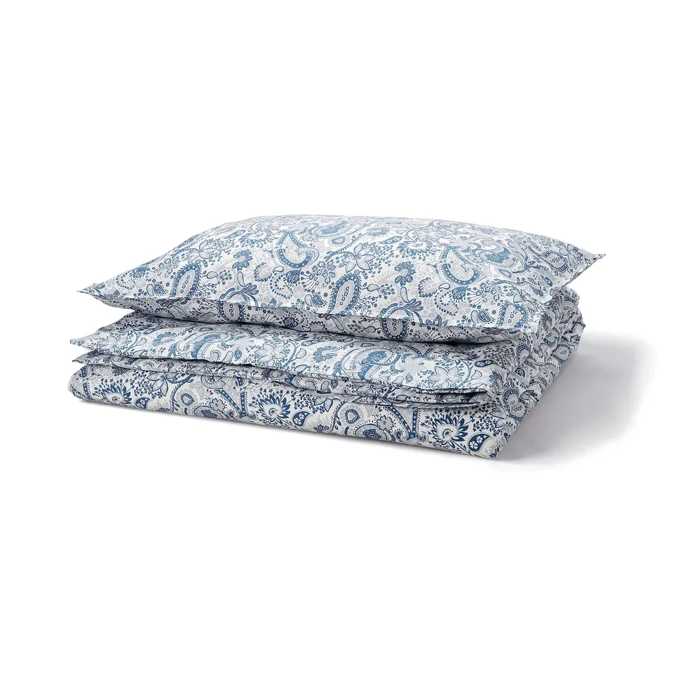 Accurate stacked blue paisley patterned bedding in geometric shape, RODGERSIA brand.
