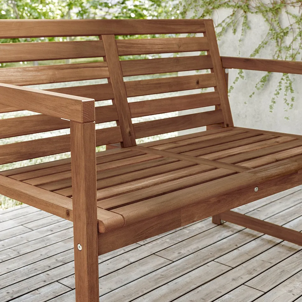 Wooden outdoor bench, brown, acacia wood. Slatted design, sturdy, natural finish.