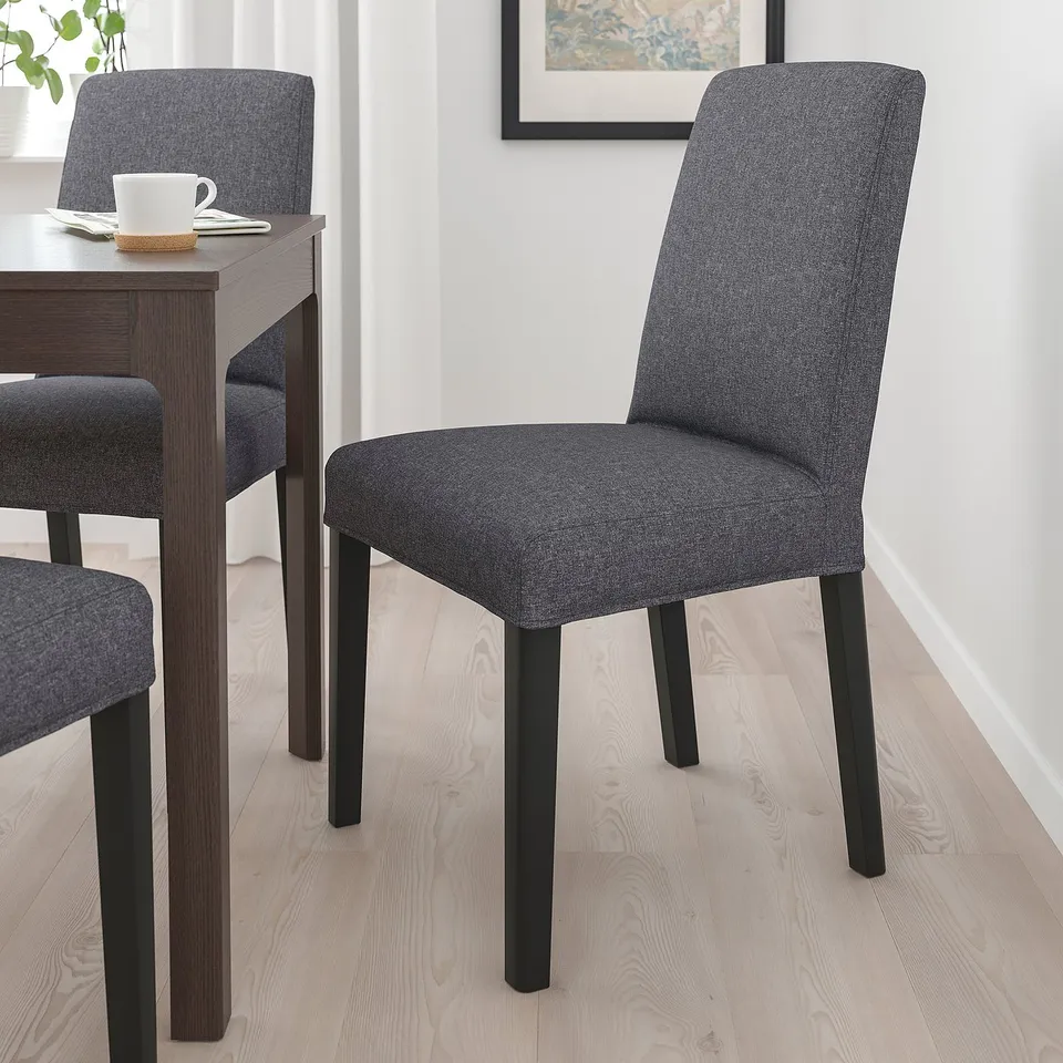 Modern dining room with 3 grey BERGMUND chairs & wooden table.