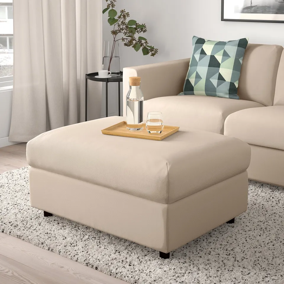 Beige VIMLE footstool with storage, matching sofa, tray with drinks, plant.