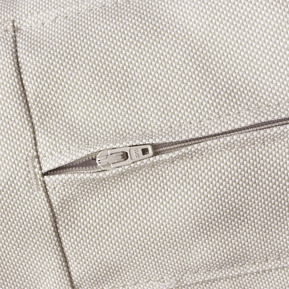 Zip detail on textured beige cushion cover.