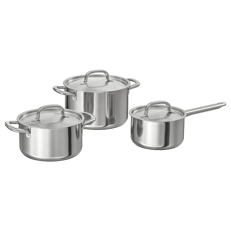 Displays a set of stainless steel pots and saucepans from IKEA 365+, featuring lids and sturdy handles, suitable for various cooktops and oven use.
