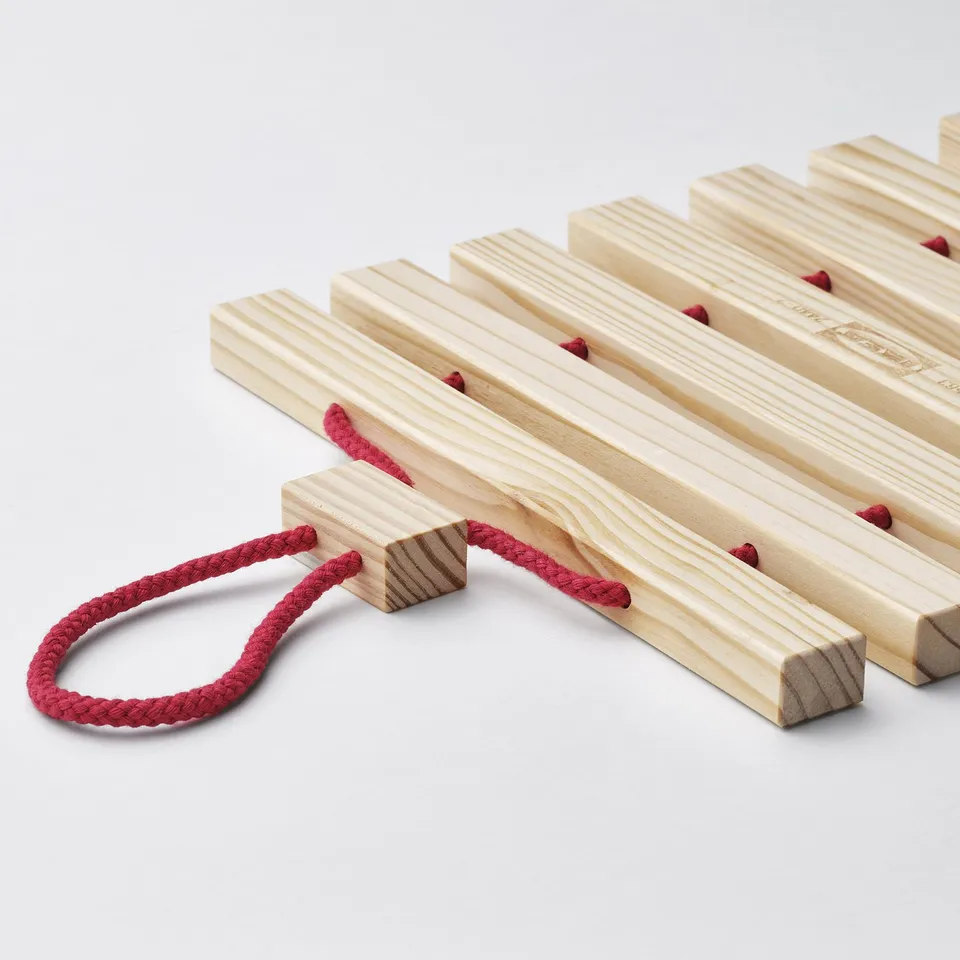 Collapsible wooden stand, red rope handle.