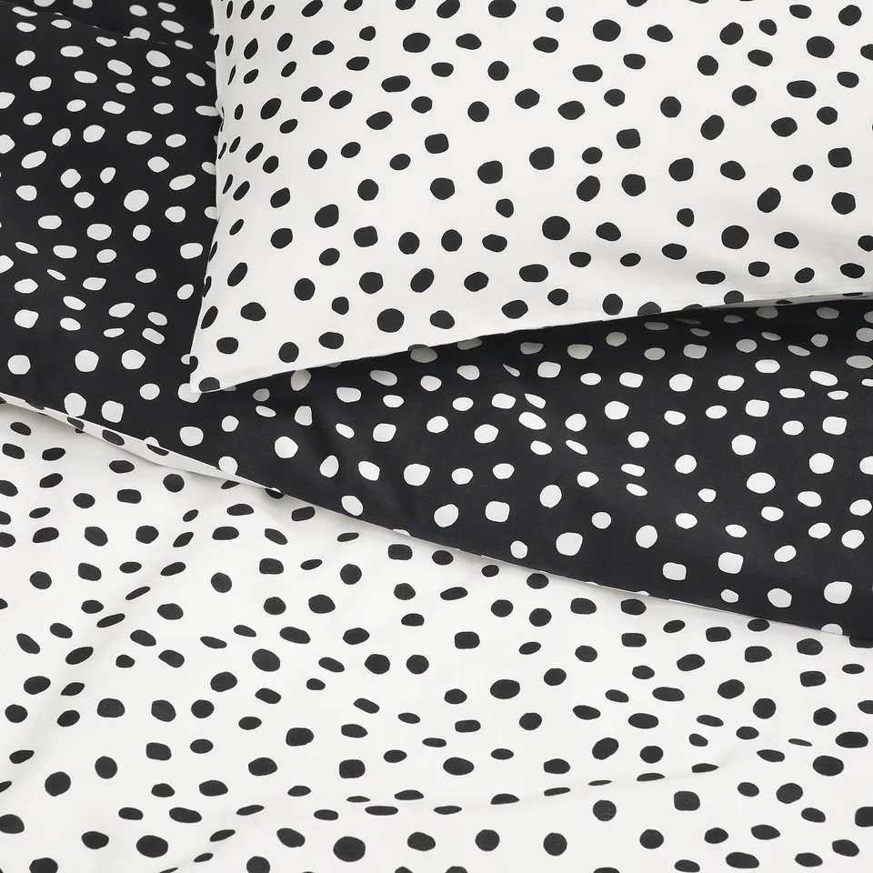 Pillowcases with black and white polka dot pattern, soft fabric, neatly folded.