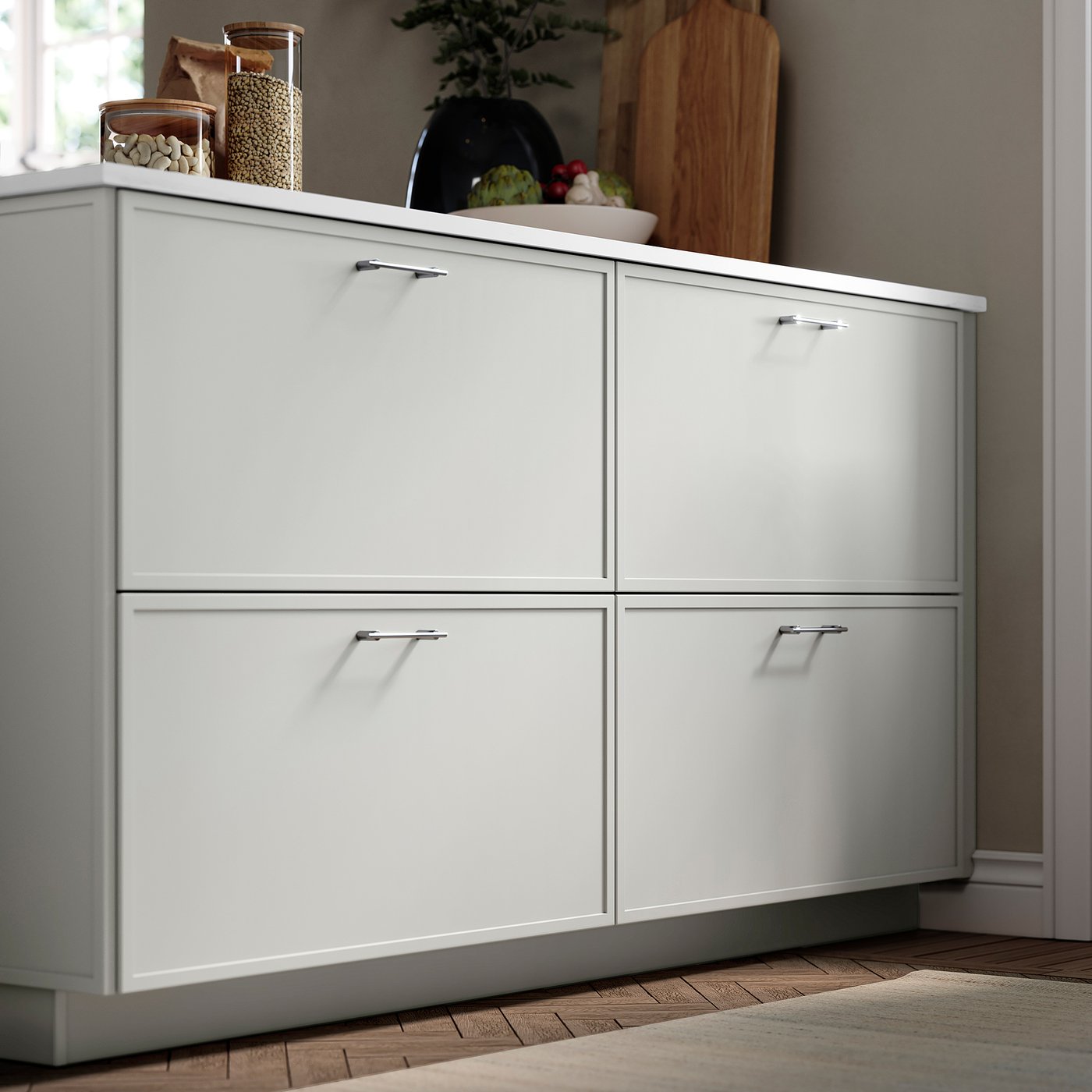 Grey ASPUDDEN cabinet with thin frame, four doors, and kitchen items on top.