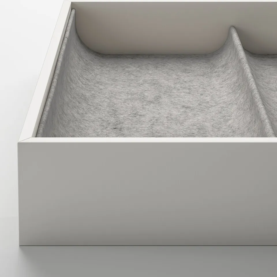 Modern KOMPLEMENT drawer with plush grey interior and smooth, safe closure.