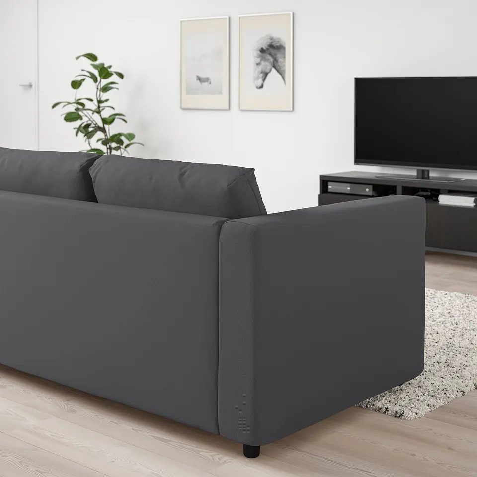 VIMLE grey sofa in modern living room, with tv and plant. Sofa is large, plush, and a central piece.