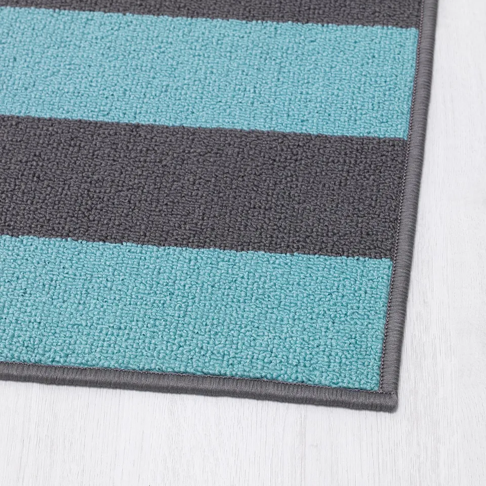 Striped indoor mat, grey and blue, textured surface. Strong, non-slip backing.