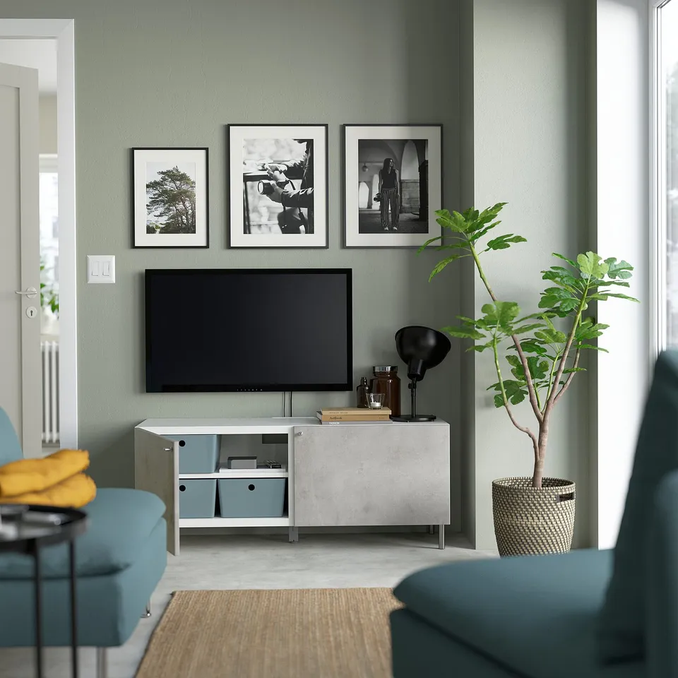 Modern living room with a BESTÅ tv unit featuring adjustable shelves, cable management, soft-closing doors, and framed art above.