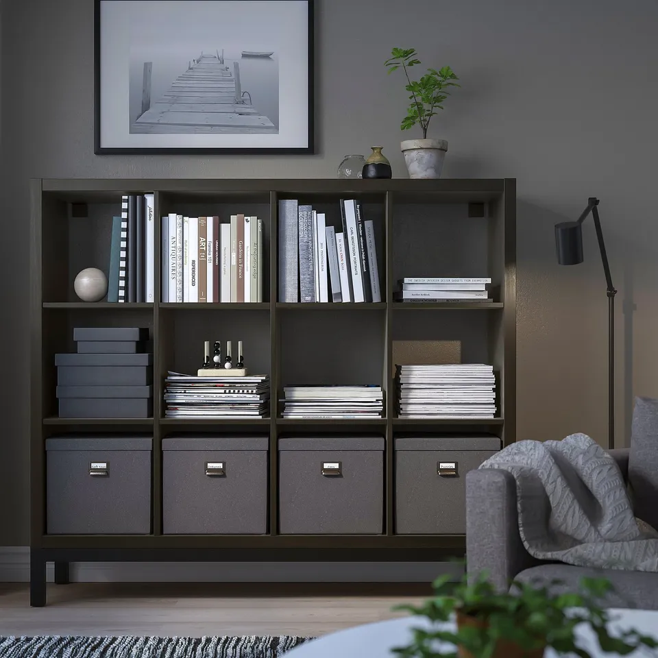 KALLAX black shelf with books & decor. Closed bins, open shelves, art, plant, sofa.