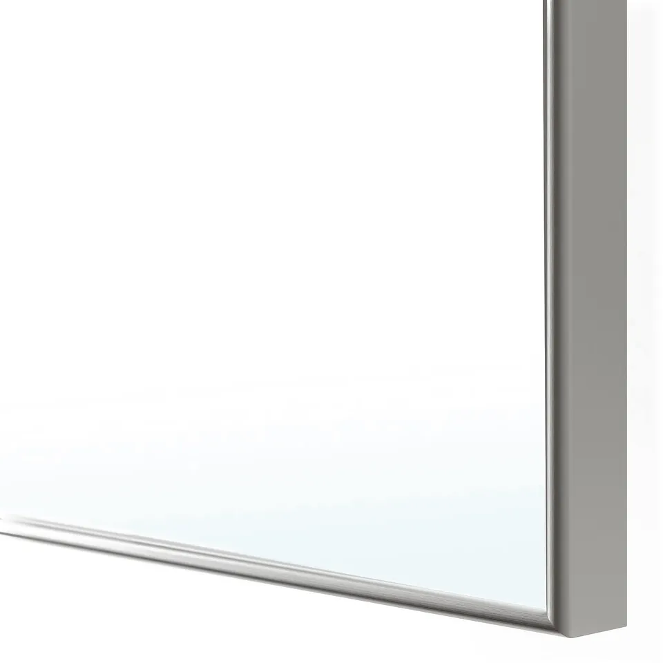 Close-up of modern, silver-framed mirror showing sleek design, sturdy edges, and polished finish.