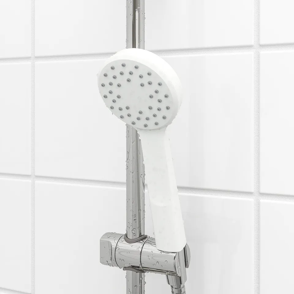Wall-mounted shower head with multiple nozzles and chrome fixtures.