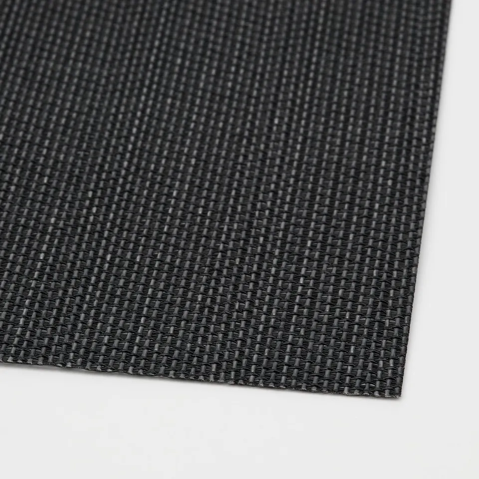 Black woven plastic placemat, neatly folded, showcasing textured surface and clean edges.