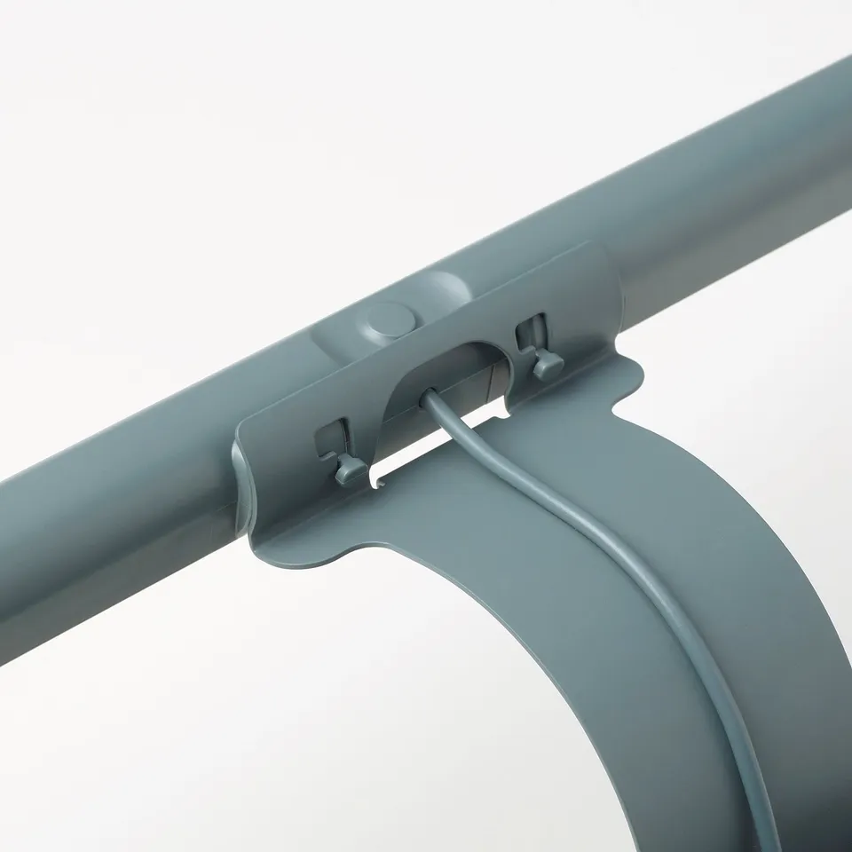 Grey plastic lamp attachment with magnetic clip and adjustable arm.