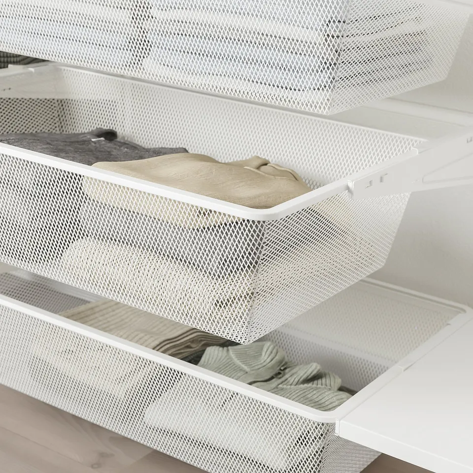 White mesh storage drawers with clothes. Ideal for organising and maximising space in wardrobes or bedrooms.