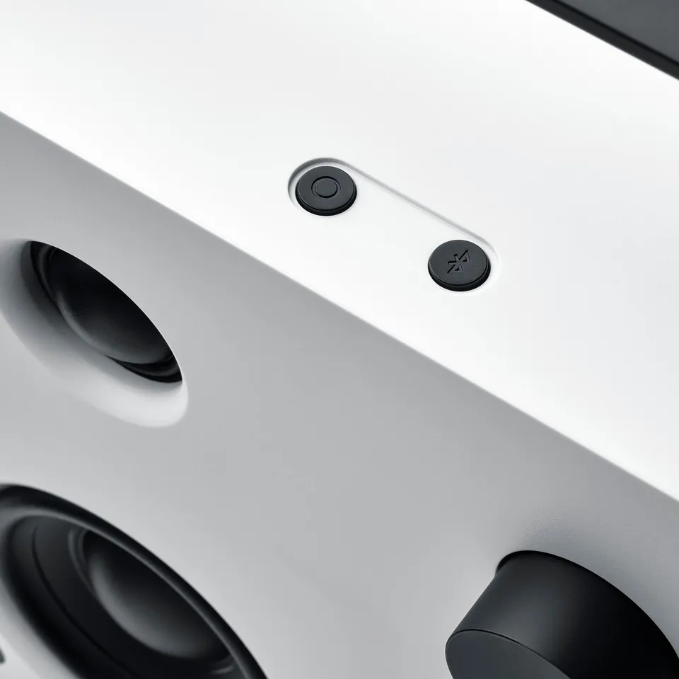 Top view of modern bluetooth speaker, sleek design with touch controls.